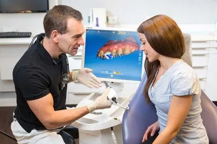 dentist talking to woman by CEREC machine, CEREC dental crowns Acton dentist