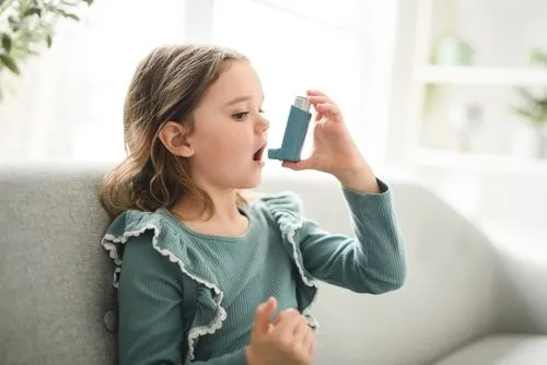 Young girl preparing to use an inhaler for asthma relief.