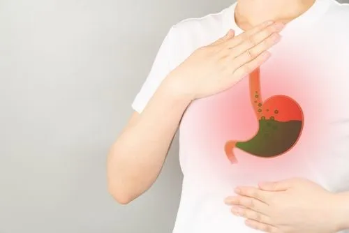 Woman with GERD holding her chest due to acid reflux discomfort