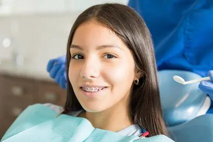 girl with braces sitting in dental exam chair, orthodontic treatment Rocky River, OH orthodontics