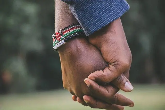 couple holding hands 