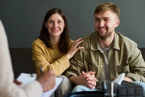 Therapist guiding a couple through a counseling session.