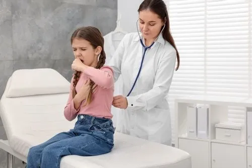 Pediatrician examining a child diagnosed with whooping cough.
