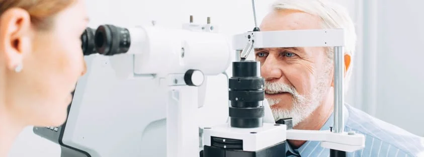 Older male having eye examined