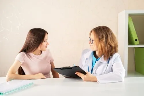 Teenager receiving adolescent care from a pediatrician