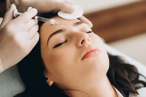 Woman undergoing forehead Botox treatment.