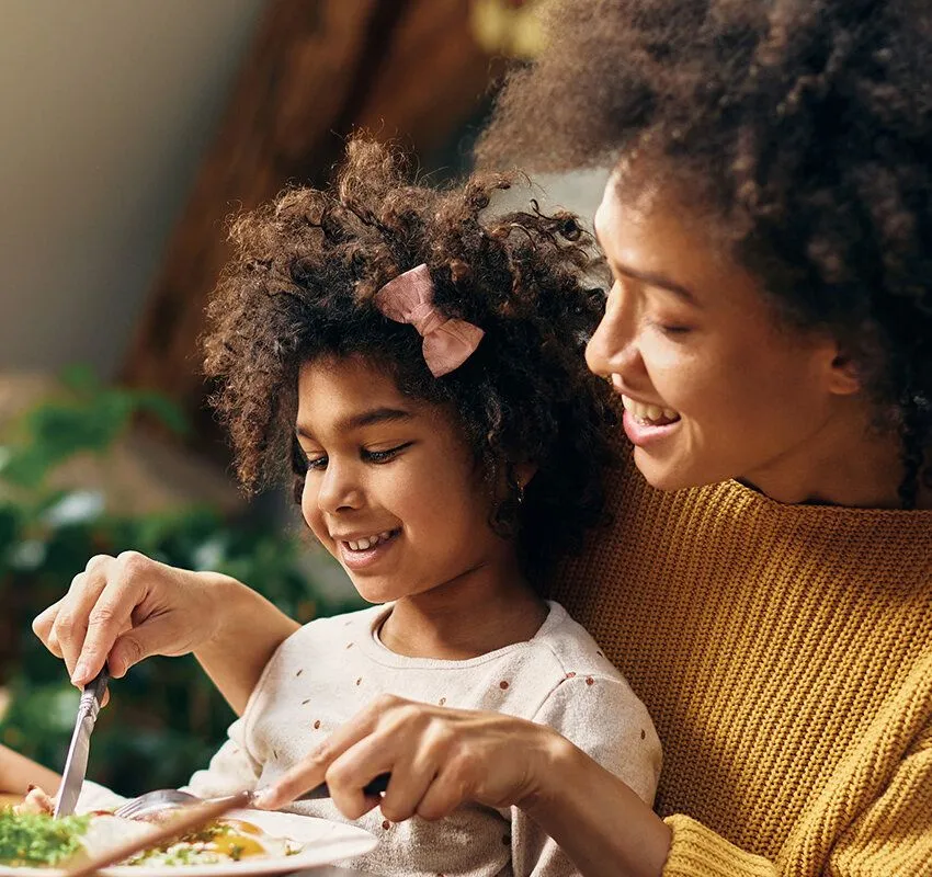 Mother and Daughter Eating Dinner