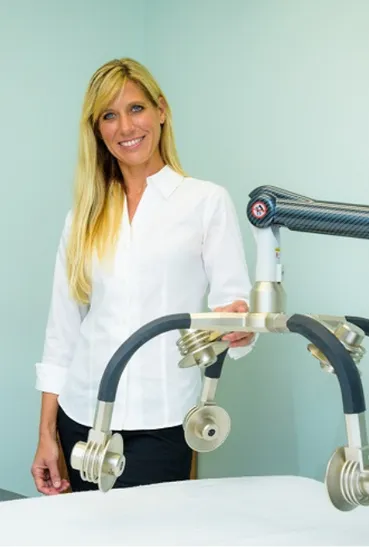 Christa standing next to the Zerona Laser