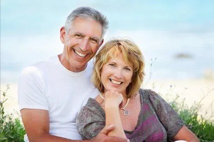 older couple at beach smiling nice dentures, dentist Wauwatosa, WI family dentist