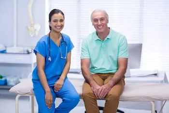 Portrait of smiling doctor and senior patient