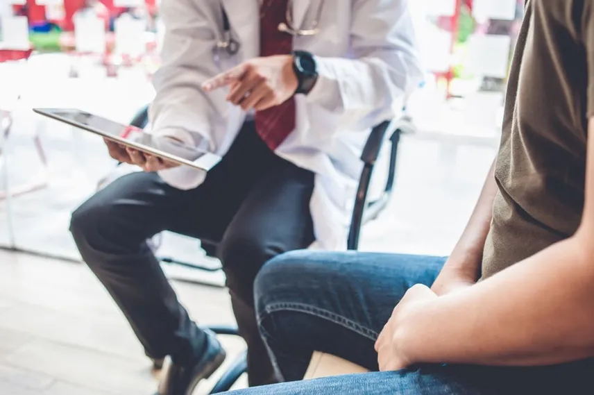 Physician evaluating car accident injury patient at Ma Kao Rehabilitation in Flushing Queens NY