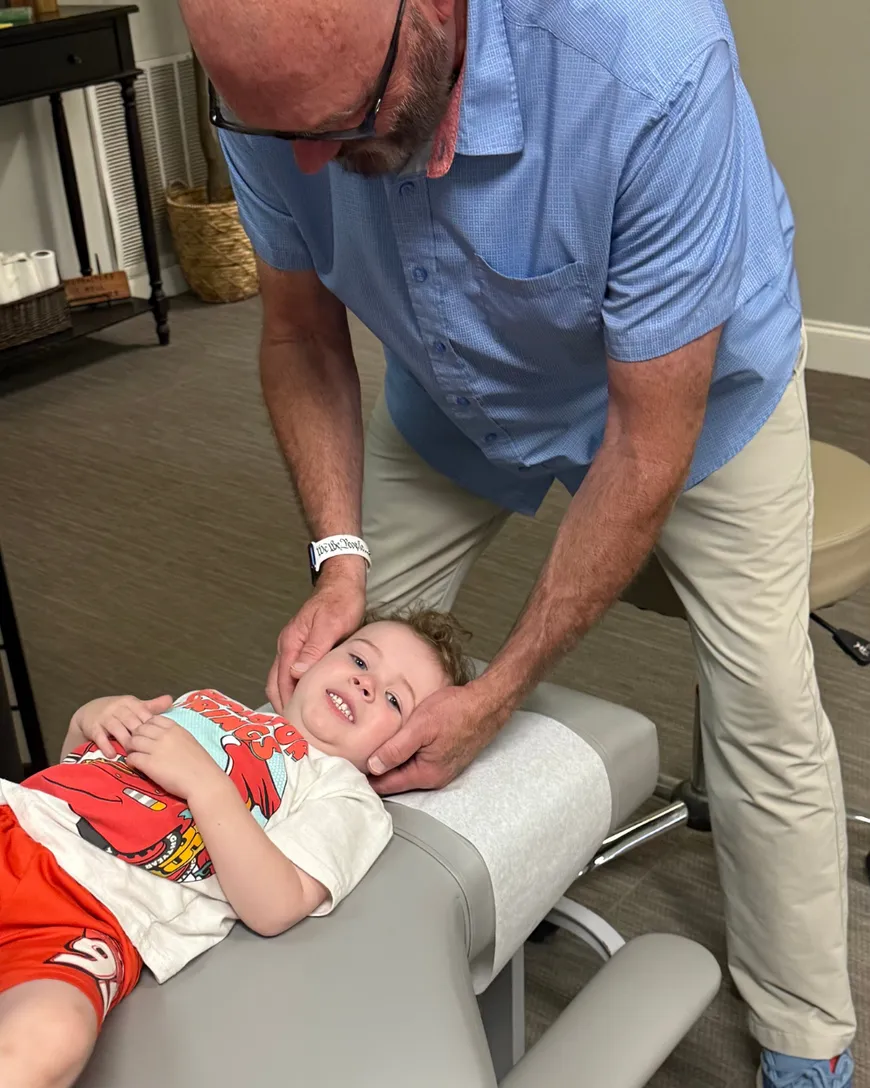 Dr. McDaniel performing a pediatric adjustment on a small child