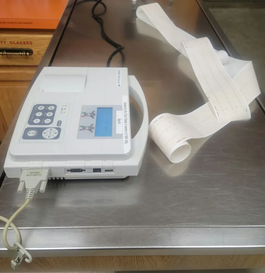 ECG machine with the papervtracing of a patient's heart electrical activity.