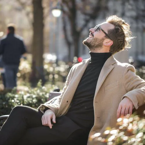 happy white man outside on bench