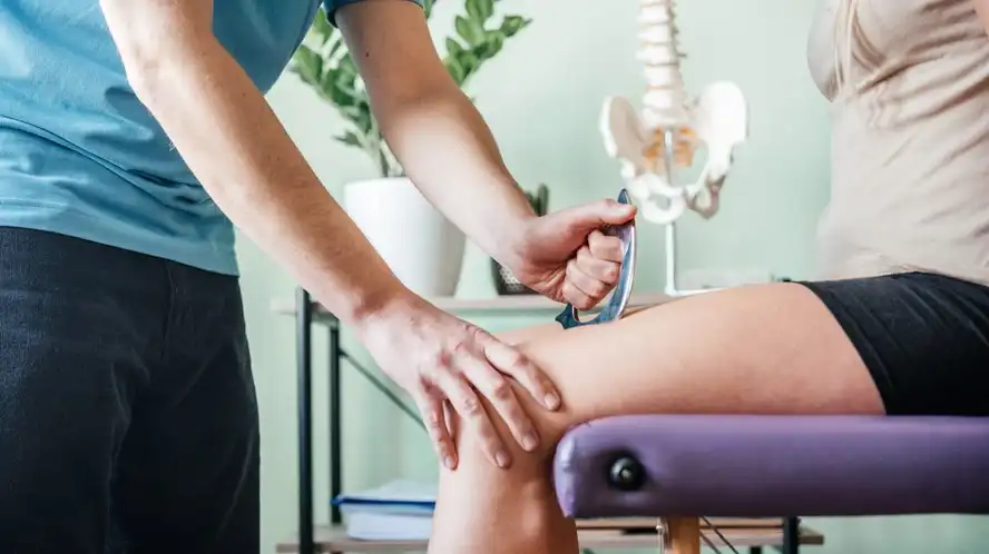 Chiropractor doing IASTM treatment to the patient