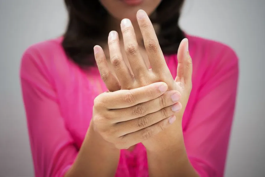 A woman holding her hand