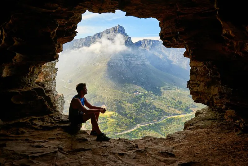 man sitting in a cave
