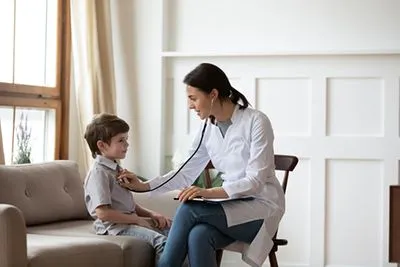 Doctor checking the young boy on clinic