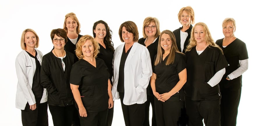 Image of team in black medical scrubs against white background