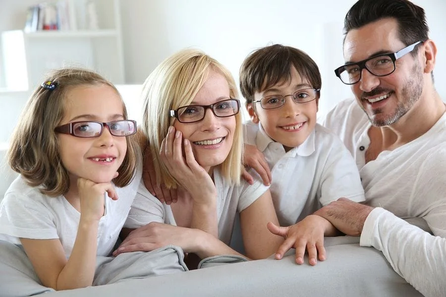 family all wearing glasses looking at the camera