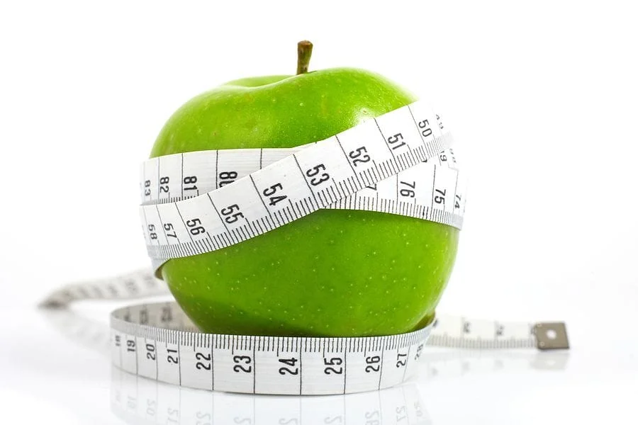 apple with measuring tape around it