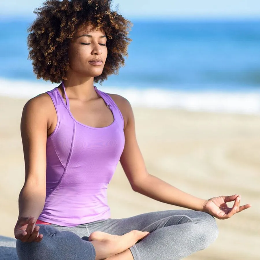 Woman meditating on beach