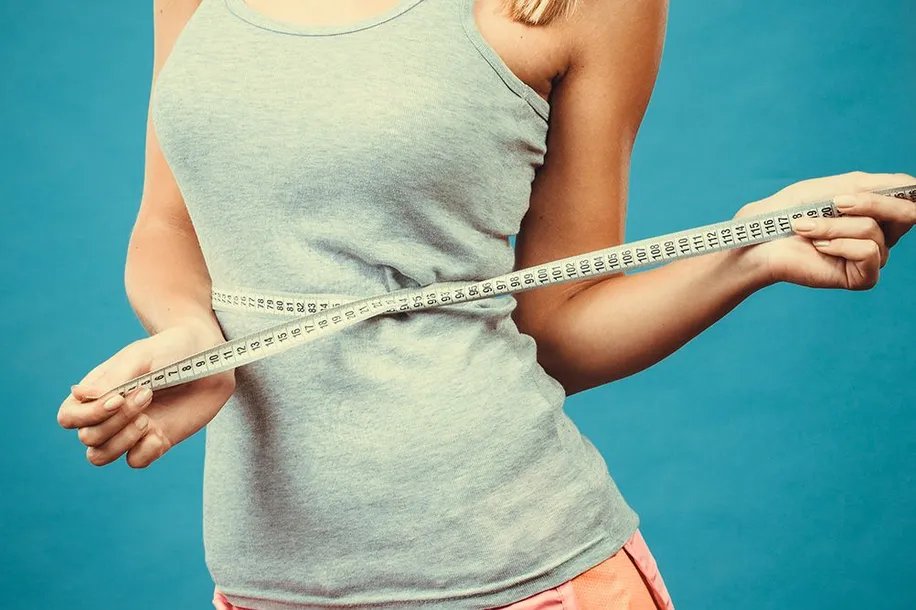 Woman holding a tape measure