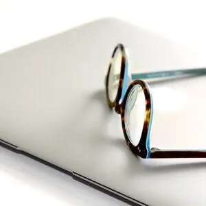 Glasses on top of a laptop