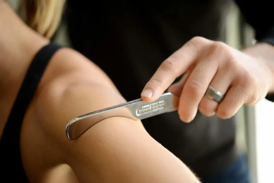 Women having arm treated with tool