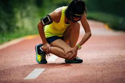 Injured female athlete dealing with running-related injury