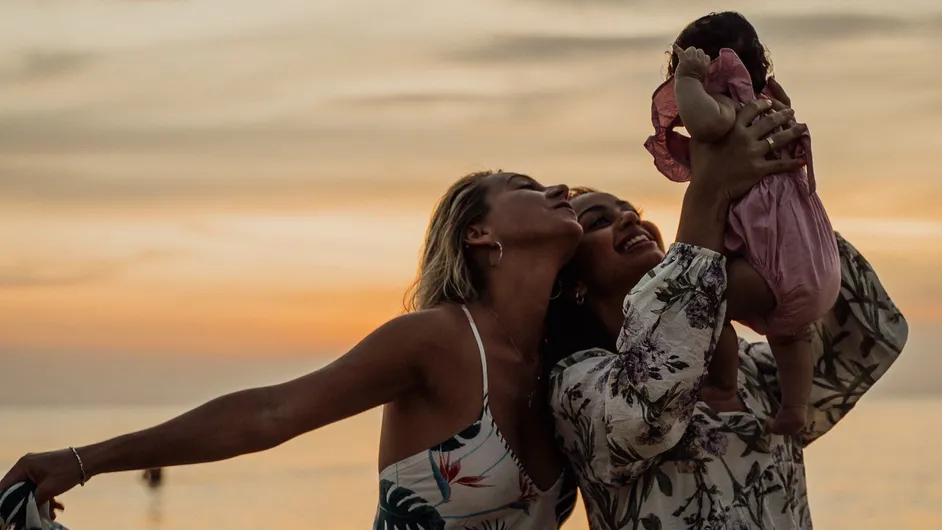 couple holding child above their head