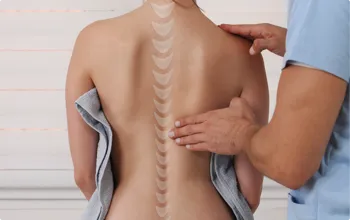 woman with a chiropractor examing her spine