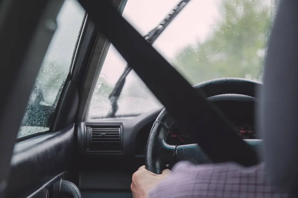 man is driving a car before an accident