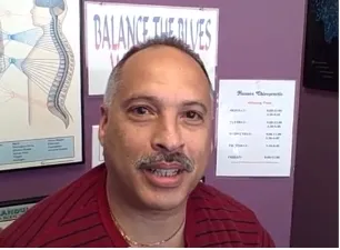 A man with red shirt smiling