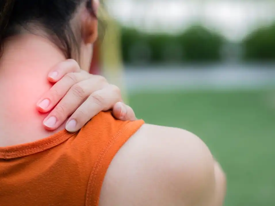 Woman with whiplash holds neck in pain 