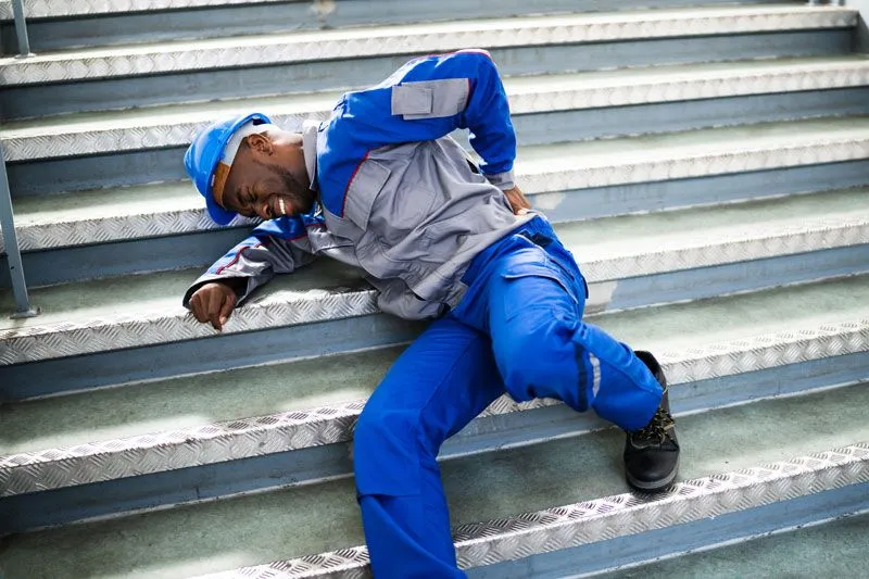 man lying on the stairs after falling