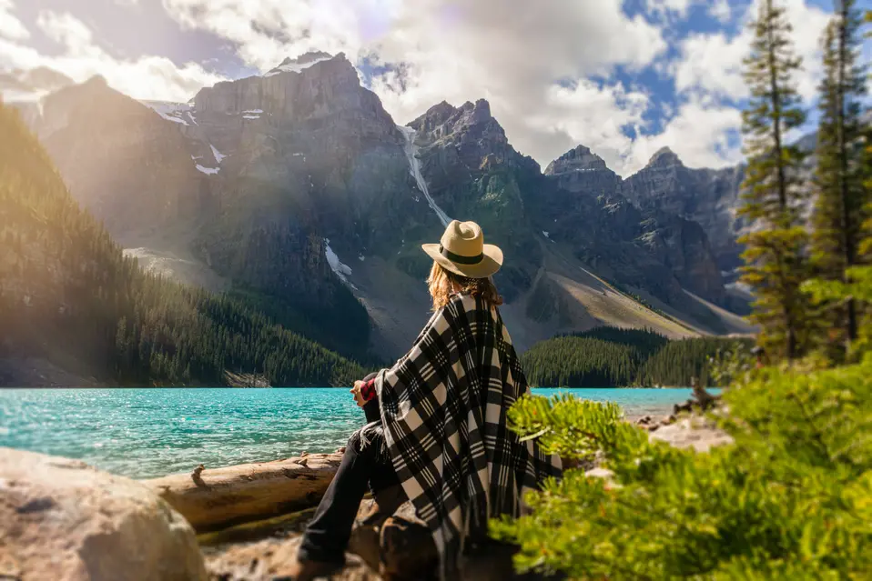 woman sitting by lake