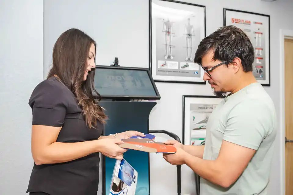 Doctor fitting a foot with orthodics