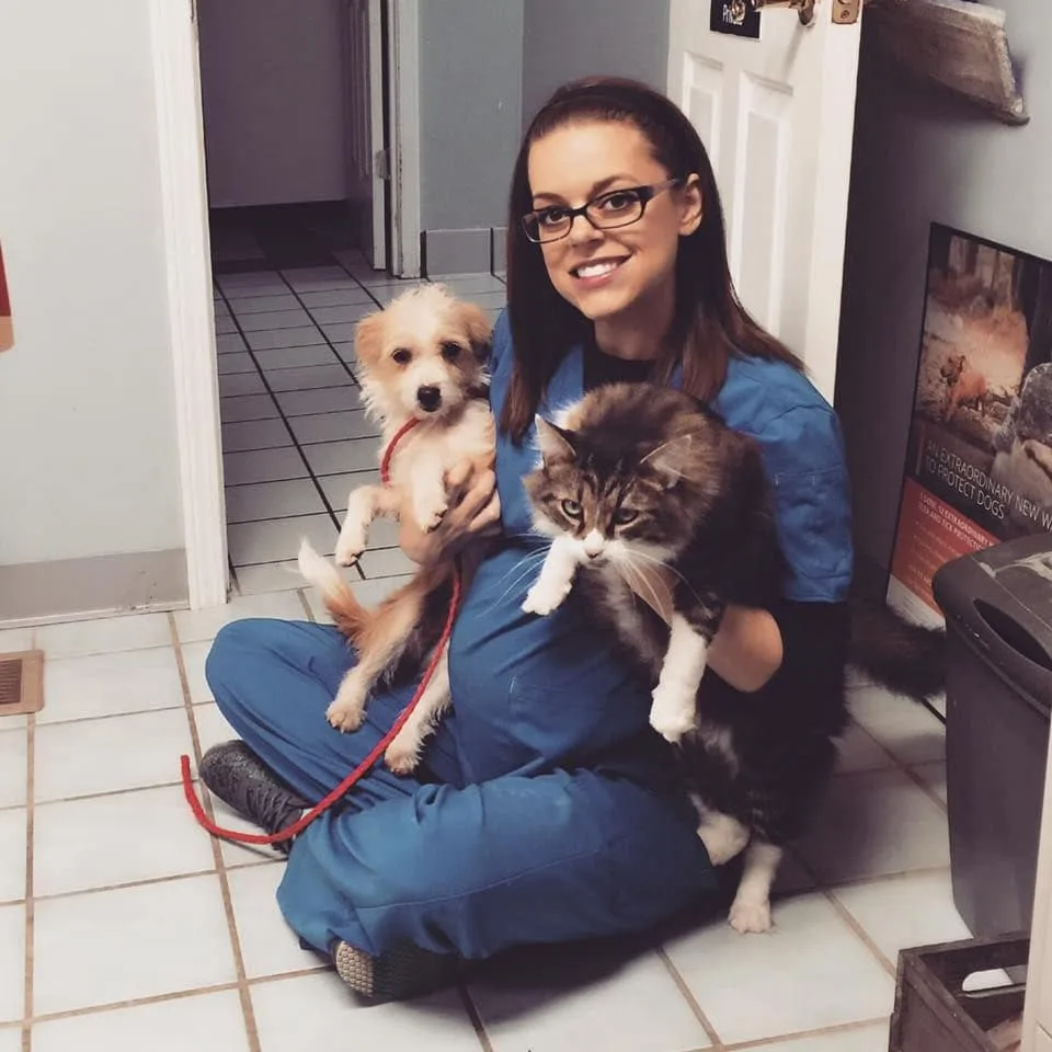Doctor holding a dog and cat