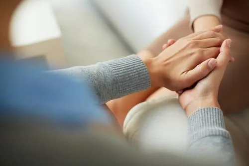 Provider holding patient's hand