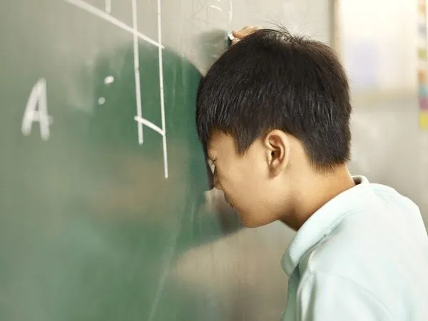 frustrated child at the chalkboard