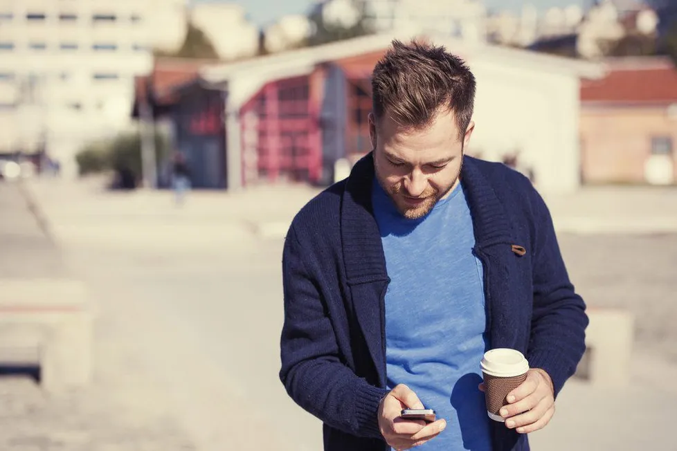 man playing with his phone