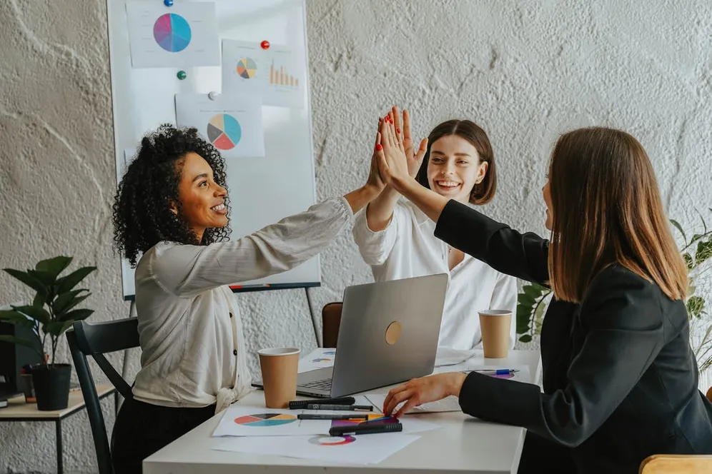 women collaborating in office