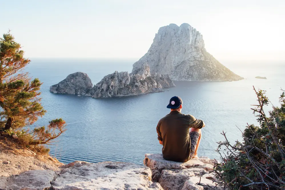 man looking at lake